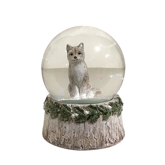 Artic wolf snow globe with bark and holly leaves accents
